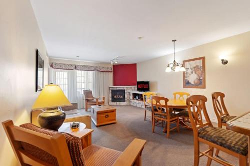 a living room with a table and a dining room at Resort Style with Balcony Hot Tub and Full Kitchen in Edgar
