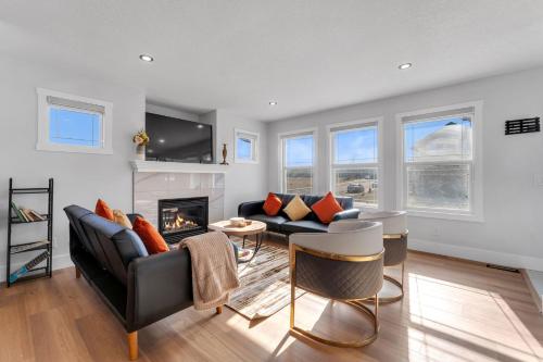 a living room with a couch and a fireplace at Your Pleasant stay in 3 bedroom House in Saddle-Ridge in Calgary