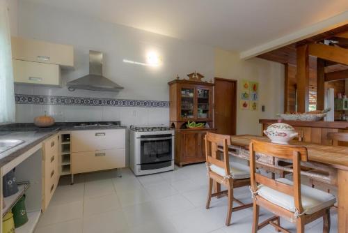 a kitchen with a table and some chairs in it at Fazenda Góes in Conde