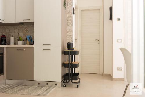 a kitchen with white cabinets and a counter at La casa di zia Maria in Pozzuoli