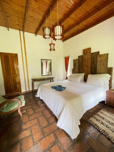 a bedroom with a large white bed in a room at Estancia La Cinacina in San Antonio de Areco