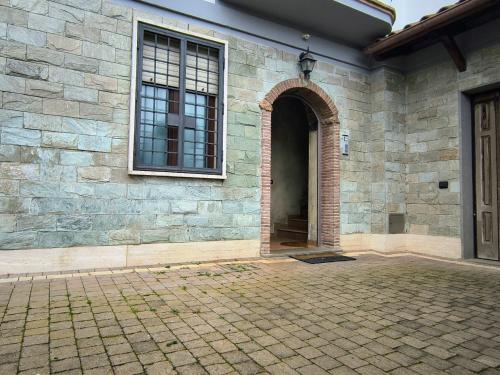 an entrance to a brick building with a window at Casa Vacanze Parco Azzurro - Il tuo angolo di tranquillita' ai Castelli Romani in Monte Compatri