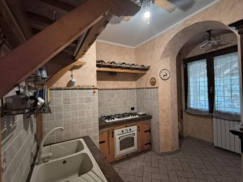 a kitchen with a sink and a stove top oven at Casa Vacanze Parco Azzurro - Il tuo angolo di tranquillita' ai Castelli Romani in Monte Compatri
