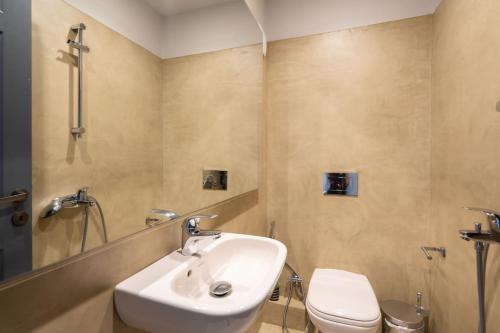 a bathroom with a sink and a toilet at Luxe Bliss 2BR, Glyfada in Athens