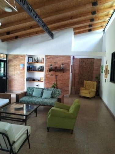 a living room with a couch and chairs and a table at Casa Campestre con piscina privada- Anapoima in Anapoima