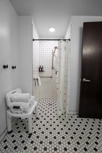 a bathroom with a shower and a sink and a toilet at Brewhalla Hotel in Fargo