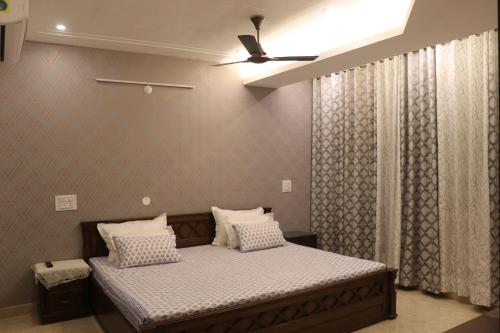a bed with two pillows on it in a room at Little Sparrow Home Stay in Rishīkesh