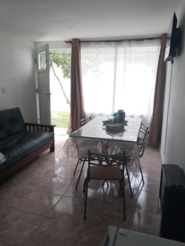 a living room with a table and a couch at Frutos de la Tierra in Comodoro Rivadavia