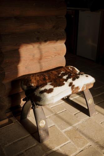 a cow sitting on top of a wooden bench at Wild&Free Private Lake in Nagycsepely