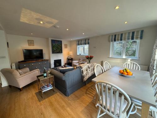a living room with a couch and a table with oranges on it at Suzetta Cottage in Seaview