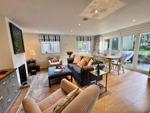 a living room with a couch and a table at Suzetta Cottage in Seaview