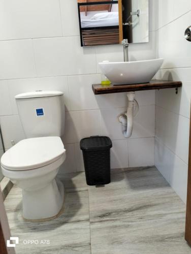 a bathroom with a white toilet and a sink at Casa Campestre con piscina privada- Anapoima in Anapoima