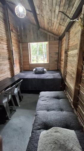 a small room with a bed and a window at Cabana in Santo André