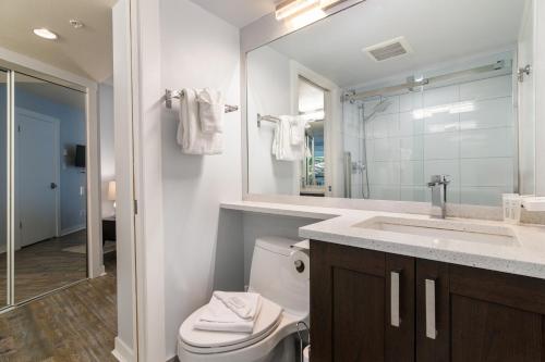 a bathroom with a toilet and a sink and a mirror at Luxury 2-Bed Whistler Village in Whistler