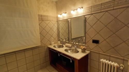 a bathroom with two sinks and a mirror at Casa San Roque in Villanueva de Arosa