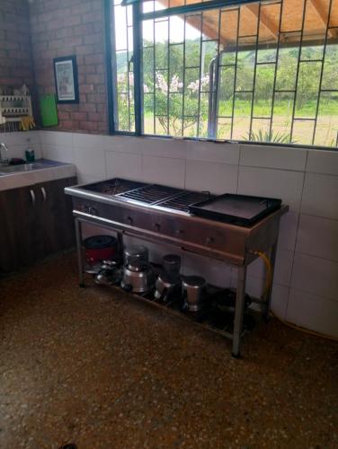 a kitchen with a stove with pots on it at Casa Campestre con piscina privada- Anapoima in Anapoima