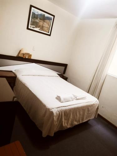 Postel nebo postele na pokoji v ubytování Hostal LATlNO