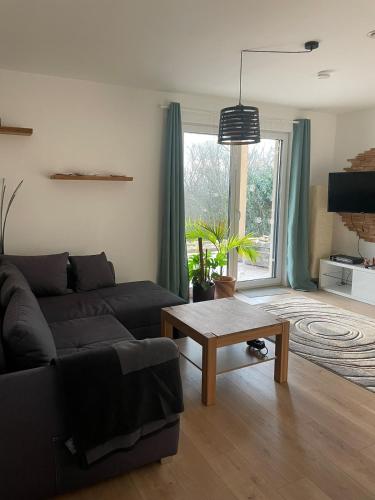 a living room with a couch and a table at gemütliche Ferienwohnung in Valwig