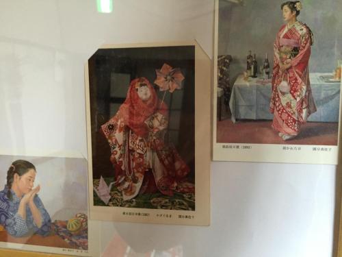 two pictures of women in kimonos on a wall at Kyoto Guesthouse Oyado Kei in Kyoto