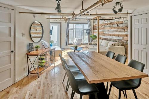 a dining room and living room with a wooden table and chairs at Lion's Den // Spacious 1500 sqft (2 WC) - Downtown in Quebec City