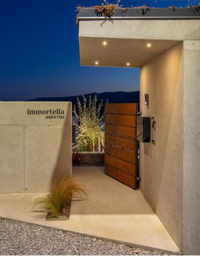 a door to a building with a sign on it at Green Tree Villas - Villa Immortella in Rabac