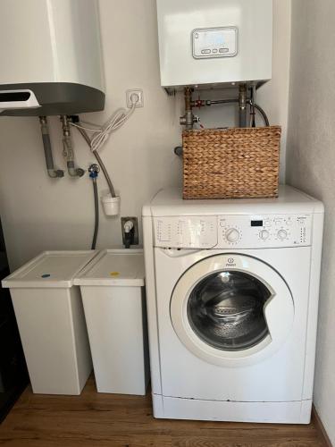 a laundry room with a washing machine and a lamp at Randy's House Plzeň in Plzeň