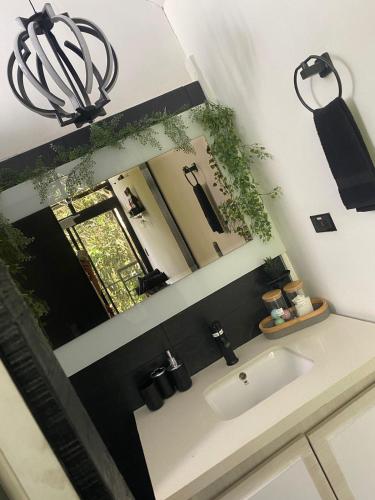 a bathroom with a sink and a mirror at Cabaña Lambrusco - La Cava Lodge in Medellín