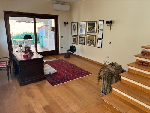 a living room with a desk and a stair case at Grandma Lella in Carbonia