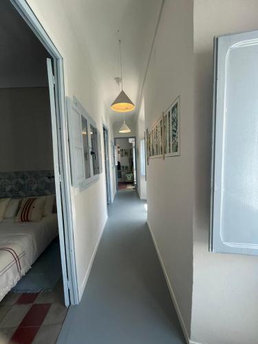 a hallway of a room with a bed and a window at Casa EA in Cazorla