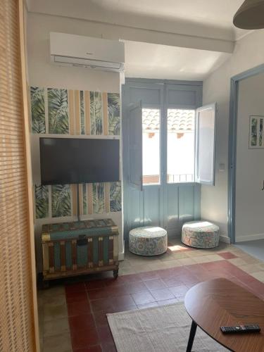 a living room with two windows and a table at Casa EA in Cazorla