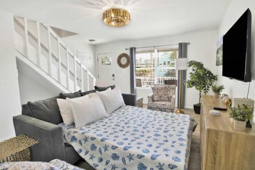 a living room with a couch and a tv at Private Beach-Private Pool-Easy walk to the Beach in Gulf Highlands