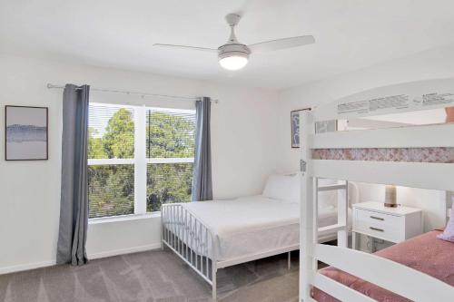 a bedroom with two bunk beds and a window at Private Beach-Private Pool-Easy walk to the Beach in Gulf Highlands
