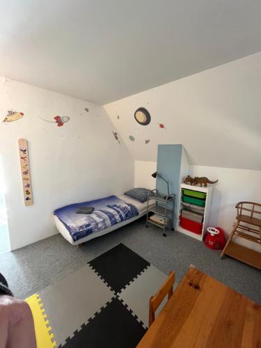 a bedroom with a bed and a table in it at Randy's House Plzeň in Plzeň