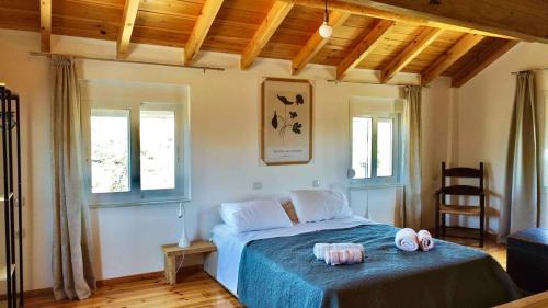 a bedroom with a bed with two towels on it at Villa Voleonas-private pool & olive grove Chania in Kounoupidhianá