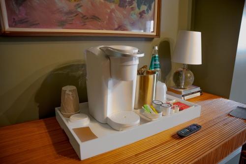 a white coffee maker sitting on a table at The Woodward Hotel in Macon