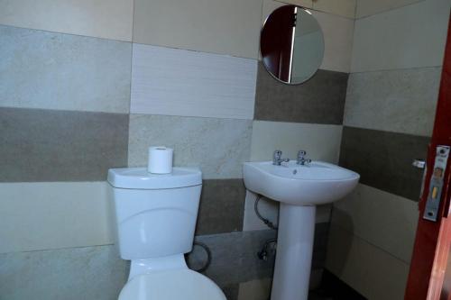 a bathroom with a toilet and a sink at Yeoville Hotel in Johannesburg