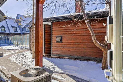 a heater outside of a house in the snow at Cozy Mountain Chalet at Mystic Springs with Pool & Hot Tub Access in Canmore