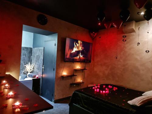 a room with a room with a fire on the wall at Love Room Jacuzzi in Lyon
