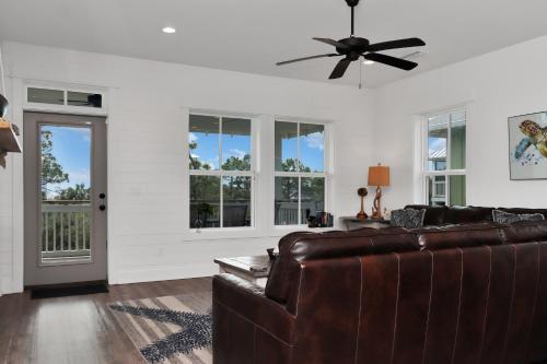 a living room with a couch and a ceiling fan at Turtle Time by Pristine Properties Vacation Rentals in Indian Pass