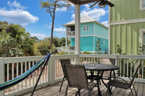 a porch with a hammock and a table and chairs at Turtle Time by Pristine Properties Vacation Rentals in Indian Pass