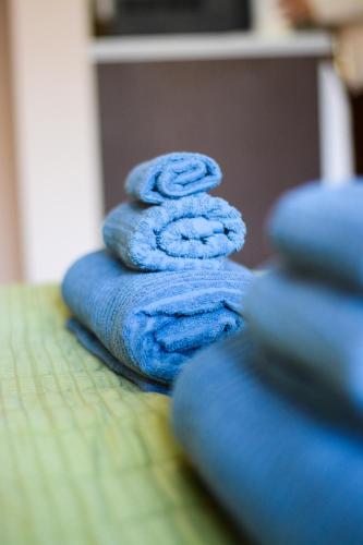 a stack of blue towels sitting on a table at Romance Studio-steps from theSea in Varna City