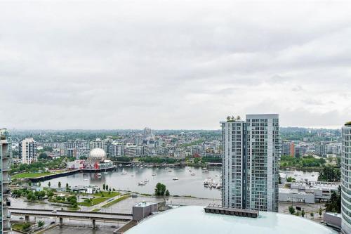 a view of a river in a city with buildings at Home in the Sky with Gorgeous Water Views in Vancouver