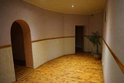 an empty room with a hallway with a potted plant at Hotel Erfolg in Daugavpils