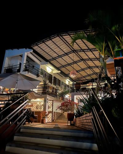 a building with stairs and an umbrella at night at Terrazas de San Agustin Hotel in San Agustín