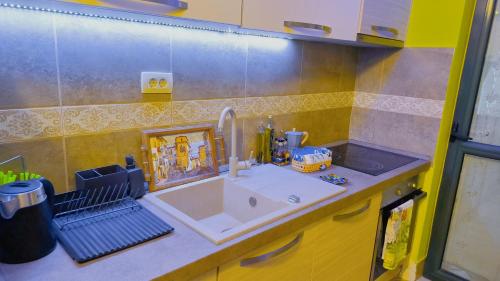 a kitchen with a sink and a counter top at Apartament - Lisa in Budva