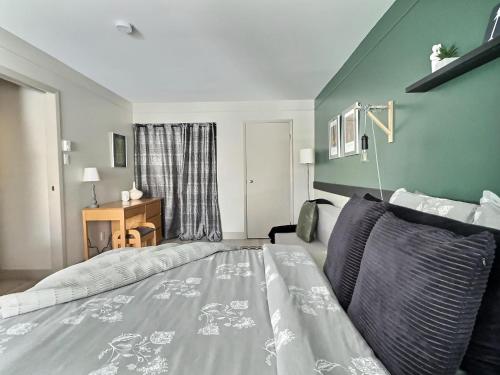a bedroom with a large bed and a couch at The Sunny Paradise in Mont-Tremblant
