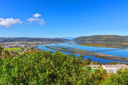 a view of a river with a bridge in the background at Lagoon Studio - Maison Mahogany - design meets breathtaking views of lagoon in Knysna