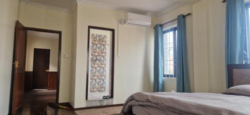 a bedroom with a bed and a door with a mirror at Myra 3 bedrooms whole house in Kathmandu