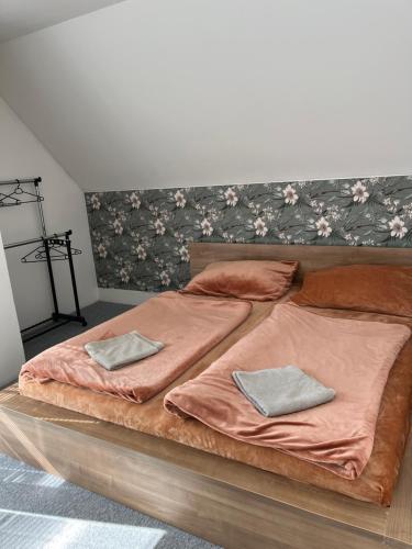 a large bed with two pillows on top of it at Randy's House Plzeň in Plzeň