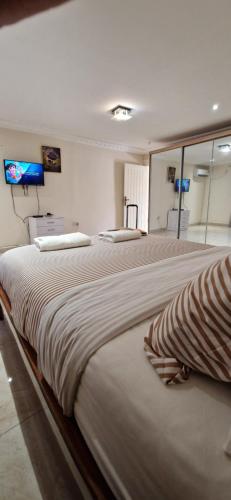a large bedroom with two large beds in it at Crisba B&B in Freetown
